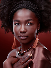 Image showing Natural beauty, portrait and black woman with fashion in studio isolated on a red background. Face, makeup cosmetics and serious African model with stylish outfit, traditional jewelry or aesthetic.