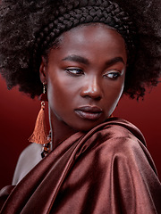 Image showing Natural beauty, idea and black woman with fashion in studio isolated on a red background. Aesthetic, makeup cosmetics and African female model with stylish outfit, traditional jewelry and culture.