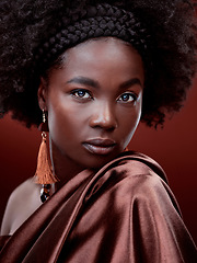 Image showing Face, natural beauty and black woman with fashion in studio isolated on a red background. Portrait, makeup cosmetics and serious African model with stylish outfit, traditional jewelry and aesthetic