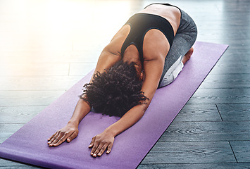 Image showing Yoga, workout and wellness with a woman in studio on an exercise mat for inner peace or to relax. Health, fitness and zen with a female athlete or yogi in the childs pose for balance or mindfulness