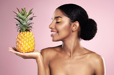 Image showing Woman, pineapple and smile for beauty in studio, pink background and healthy vitamin c cosmetics. Happy african model, tropical fruits and nutrition for natural skincare, organic benefits and detox