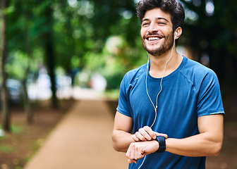 Image showing Fitness, music and man with a watch for time, running progress and heart results in a park. Smile, thinking and a male athlete listening to a podcast or audio while checking notification on a device