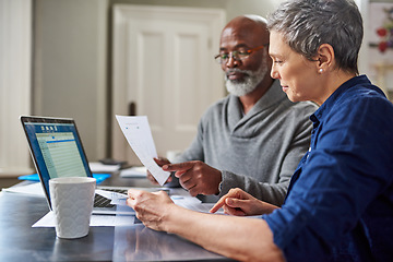 Image showing Laptop, documents and finance with a senior couple busy on a budget review in the home together. Accounting, taxes or investment planning with a mature man and woman looking at insurance or savings