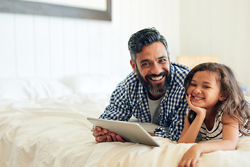 Image showing Happy, portrait and digital tablet by girl with father on a bed, relax and browsing for entertainment in their home. Face, smile and parent and with child in bedroom online for streaming or reading