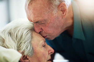 Image showing Senior, kiss and couple in hospital for healthcare, visiting sick patient and hope for recovery. Clinic, elderly man and woman kissing on forehead with love, care and empathy, kindness and comfort.