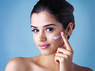 Image showing Skincare, portrait of woman with face cream and in blue background. Beauty, cosmetic treatment and happy female model pose with sunscreen for skin care or health wellness in studio backdrop.