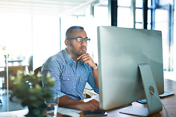 Image showing Business man, thinking and computer at desk in office for online research, reading email or report. Male entrepreneur person with internet connection for feedback, review and focus on project