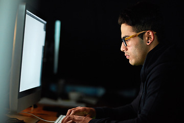 Image showing Computer, typing and man at night for software development, programming update and information technology. Focus, research and geek or programmer person on desktop screen for website cyber security