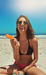 Image showing Ice cream, beach smile and woman portrait on holiday by the sea and blue sky with happiness. Sun, sand and young female person face with a happy travel and lens flare by ocean in summer on vacation