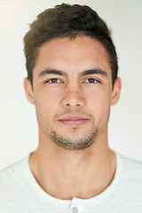 Image showing Portrait, face and headshot of man in studio, isolated white background and posing with casual attitude. Handsome young guy, serious male person and pose for ID photo, passport picture and confidence