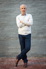 Image showing Portrait, business and mature man with arms crossed, entrepreneur and confident guy against a brick wall. Face, male person and employee with startup success, formal and professional with a career