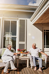 Image showing Cheers, patio and senior couple with juice enjoying bonding, quality time and relax in morning. Love, retirement and happy elderly man and woman smile with drink for breakfast outdoors at home