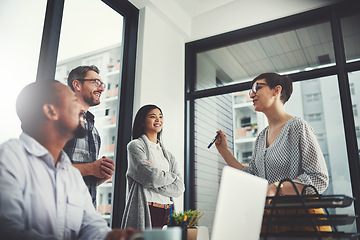 Image showing Teamwork, laptop and smile with business people in meeting for project management, review or planning. Technology, website and training with group of employees in office for diversity and idea