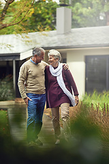 Image showing Conversation, love and elderly couple walking in their garden by the house for wellness and fresh air. Bonding, retirement and senior man and woman on path together in their backyard at modern home.