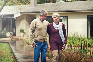 Image showing Love, garden and senior couple walking by their house for wellness, fresh air and bonding. Happy, retirement and elderly man and woman on a path together in their garden at their modern home.