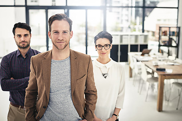 Image showing Portrait, teamwork and management with a business man and his team standing in the office together. Leadership, manager and collaboration with a group of businesspeople looking confident about work