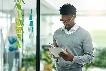 Image showing Glass wall, business tablet and black man planning, research and strategy in office workplace. Technology, board and African male professional with sticky notes for online, schedule and brainstorming