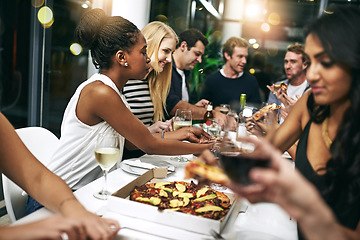 Image showing Food, party and pizza with friends at restaurant for celebration, wine and social event. Happy, diversity and night with group of people eating together for hungry, luxury and free time