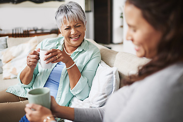 Image showing Laugh, coffee and mother with daughter on sofa in living room for bonding, conversation and happiness. Smile, chat and discussion with women talking in family home for generations, reunion and break