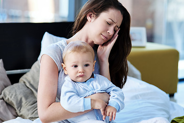 Image showing Tired, sick and a mother with a child and headache from parenting stress, burnout and sad. Fatigue, mental health and a mom with postpartum depression, anxiety or pain with a newborn at home