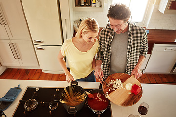 Image showing Top view, food or happy couple in a kitchen cooking with healthy vegetables for dinner meal together at home. Love or woman helping or talking to mature husband in lunch diet preparation in Australia