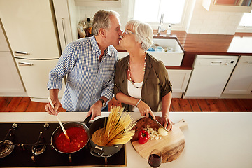 Image showing Top view, kiss or old couple kitchen cooking with healthy food for lunch or dinner together at home. Love, help or senior woman bonding or kissing mature husband in meal preparation in retirement