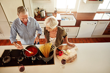 Image showing Help, support or old couple cooking food for a healthy vegan diet together with love in retirement at home. Spaghetti or top few of senior woman bonding in house kitchen with mature husband at dinner