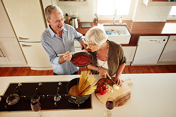 Image showing Top view, taste or old couple kitchen cooking with healthy food for lunch or dinner together at home. Love, help or senior woman tasting or eating with mature man in meal preparation in retirement