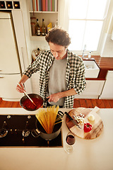 Image showing Spaghetti, cooking or above of man in kitchen with healthy vegan diet for nutrition or vegetables at home in Australia. Wine glass, food or male person in house kitchen in preparation for dinner meal