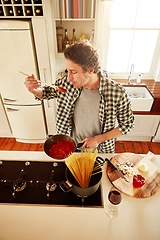 Image showing Food, cooking or man tasting in kitchen with healthy vegan diet for nutrition or vegetables at home in Italy. Spaghetti sauce taste, above or person in house kitchen in preparation for dinner meal