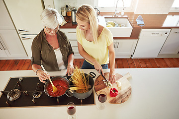 Image showing Above, woman or mother cooking food for a healthy vegan diet together with love in a happy family home. Girl, spaghetti or adult child helping senior mom in house kitchen for lunch meal or dinner