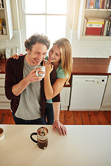 Image showing Hugging, coffee or happy couple laughing in kitchen at home bonding or enjoying quality time together. Embrace, affection or above of funny mature man relaxing or drinking tea with woman at home