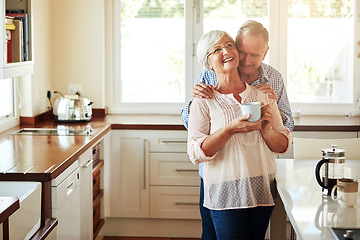 Image showing Hugging, coffee or old couple laughing in kitchen at home bonding or enjoying quality time together. Embrace, retirement or happy mature man talking, relaxing or drinking tea with funny senior woman