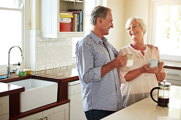 Image showing Happy, coffee or old couple laughing in kitchen at home bonding or enjoying quality morning time together. Funny, affection or mature man talking, relaxing or drinking tea espresso with woman at home