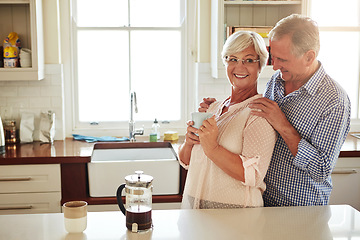 Image showing Happy, coffee or old couple hugging in kitchen at home bonding or enjoying quality morning time together. Embrace, retirement or lovely senior man talking, relaxing or drinking tea with mature woman