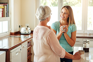 Image showing Mother, coffee or happy woman laughing in kitchen in family home bonding or enjoying quality time together. Speaking, retirement or funny girl talking, relaxing or drinking tea with senior parent