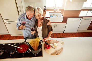 Image showing Hugging, wine or old couple cooking food for a healthy vegan diet together with love in retirement at home. Top view of senior woman drinking or bonding in house kitchen with mature husband at dinner