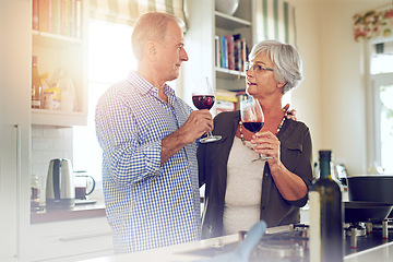 Image showing Wine, toast or old couple hug in kitchen in celebration of marriage anniversary together in retirement at home. Cheers or senior woman drinking or bonding in a house with mature husband at dinner