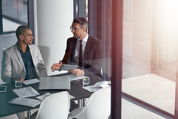 Image showing Advice, tablet and business man with partner at meeting, conference room and window reflection in financial planning. Professional people or accountant on digital tech, talking finance and accounting