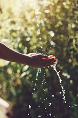 Image showing Water, splash and hydration with a person washing hands outdoor in nature for life, sustainability or moisture. Environment, stream and wet with an adult cleaning outside for wellness or hygiene