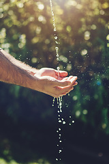 Image showing Water, wellness and hydration with a person washing hands outdoor in nature for life, sustainability or moisture. Environment, splash and wet with an adult cleaning outside for wellness or hygiene