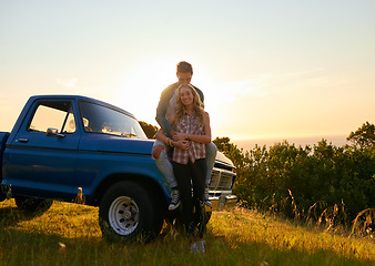 Image showing Couple, portrait and sunset by pickup truck in nature for road trip with love, romance and date on adventure. Man, woman and hug for freedom, journey and transportation for travel in countryside