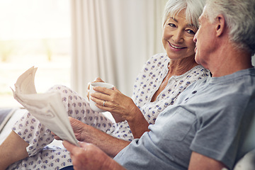 Image showing Coffee, newspaper and a senior couple in the bedroom, enjoying retirement in their home in the morning. Tea, reading or love with a happy mature man and woman in bed together to relax while bonding