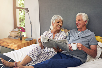 Image showing Coffee, newspaper and a mature couple in the bedroom, enjoying retirement in their home in the morning. Tea, reading or love with a happy senior man and woman in bed together to relax while bonding