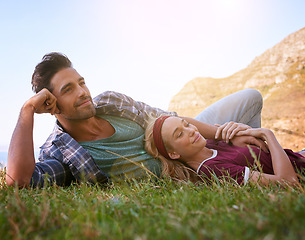 Image showing Relax, smile and love with couple in nature for mountains, bonding and affectionate. Happiness, date and romance with man and woman cuddle in grass field for summer break, happy and relationship