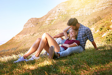 Image showing Relax, kiss and happy with couple in nature for carefree, bonding and affectionate. Happiness, date and romance with man and woman cuddle in grass field for summer break, love and mountains