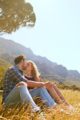 Image showing Romance, kiss and love with couple in nature for carefree, bonding or affectionate. Happiness, date and relax with man and woman cuddling in grass field for summer break, happy or relationship mockup