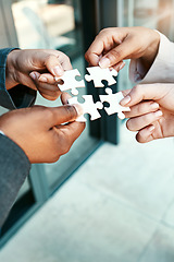 Image showing Closeup, hands and puzzle with collaboration, group and teamwork with partnership, planning and brainstorming. Zoom, staff and team with ideas, jigsaw pieces and cooperation with support and solution