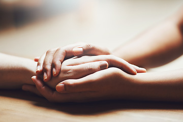 Image showing Prayer, empathy and support with people holding hands in comfort, care or understanding on a wooden table of a home. Love, faith or depression with friends closeup for help, hope or peace for healing