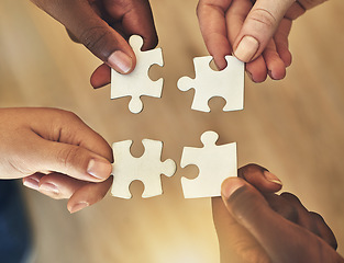 Image showing Team, hands and puzzle for teamwork and collaboration of business people for challenge or project. Above group of men and women working together on mockup jigsaw for solution, synergy or goal